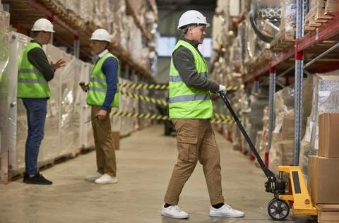 Shot of three workers doing operations in storage warehouse Stock Photos