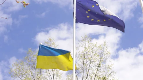 Shot through the flags of Ukraine and the European Union in the city of Irpin Stockbeeldmateriaal 188873731