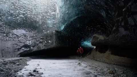 Shot of tourists walking inside the ice cave in Breidamerkurjokull, Iceland Stock Footage 120475923
