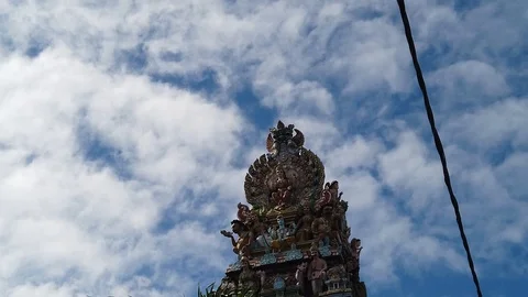 A shot of the tower of a Hindu temple full of deities as walking down the Video stock 114489922