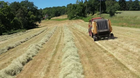 Shot of tractor doing round ballers Stock Footage 144484004