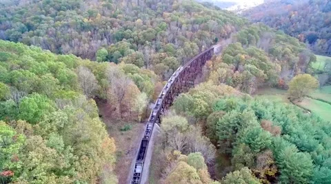 Shot of Train Passing in Beautiful Green Mountain Valley Video stock 68801892