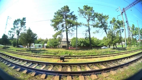 A shot from the train window. View of the summer nature, road Stock-Footage 94577753