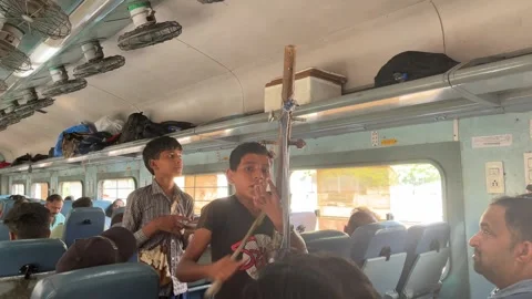 Shot of two kids begging to singing a song in train in India Vídeos de archivo 313889685