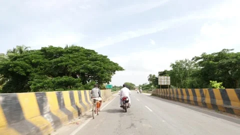 Shot of vehicles passing over river bridge in India Stock Footage 156972792
