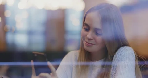 Shot of view through the window of happy young woman use phone at cafe. Smiling Stock Footage 143736805