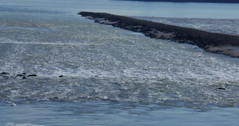 Shot of the water out flow for the Grain CHP Power Station. on the river Medway Stock Footage 331324475