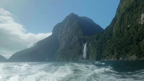 Shot of waterfall and mountains from back of boat Stock Footage 260369835