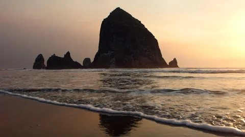 Shot of the Waves in Cannon Beach during Sunset in Slow Motion Stock Footage 246444245