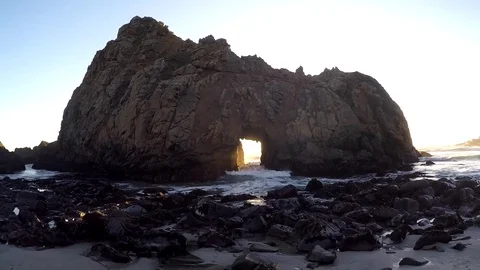 Shot of waves crashing through Rock Sun Portal at Big Sur Video stock 79577291