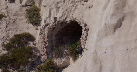 Shot of the white cliffs of Dover with a brick lined tunnel entrance in the 動画素材 329761610