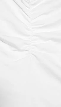 Shot of white fabric featuring a central vertical seam with gathered, ruched  Stock Photos