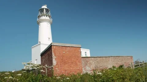 Shot of white lighthouse with blue sky Stock Footage 199960778