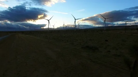 Shot of windmill generators in a field at dawn Stock Footage 79137475