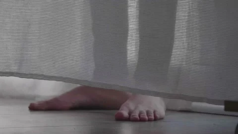 Shot of woman's foot, the curtain in the wind, the temperature is cold, the a Stock Footage 171982974