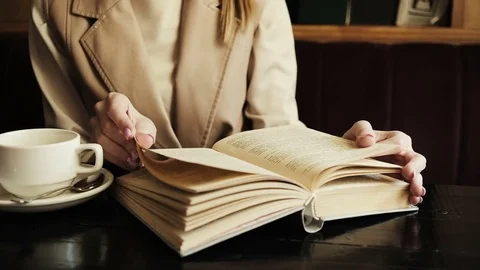Shot of woman's hand reading a book indoors. Close up Stock Footage 79884048