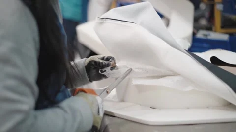 Shot of a worker fitting, cutting and stapling, fabric around a preformed Video stock 150195039