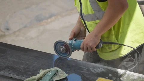 Shot with a worker while cutting a marble sheet with an angular grinder Stock Footage 116044375