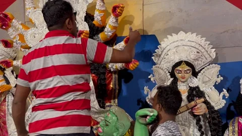 A Shot of Workers Decorating Durga Puja Pandal with Idols in India Stock Footage 332106833