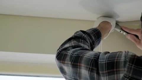 Shot of Workers stretch the stretch ceiling in the room. Close up Stock Footage 167961345