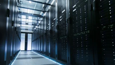 Shot of a Working Data Center With Rows of Rack Servers. People Walk and Work Stock Photos