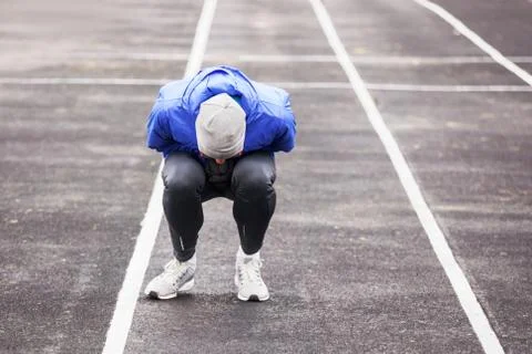 Shot of a young runner feeling bad while running outdoors. Foto stock