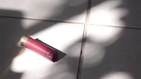 Shotgun Shell Rolling on Tile Floor Stock Footage 46694299