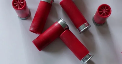 Shotgun shells scattered on white surface 動画素材 75265519