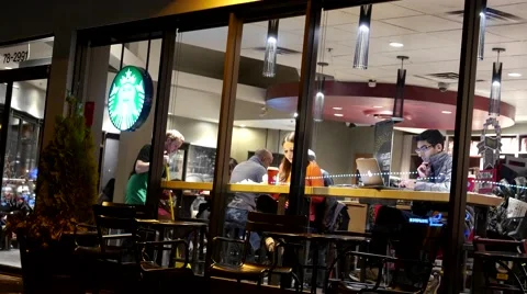Shotting from outside window of customer buying coffee at Starbucks Stock Footage 59338742