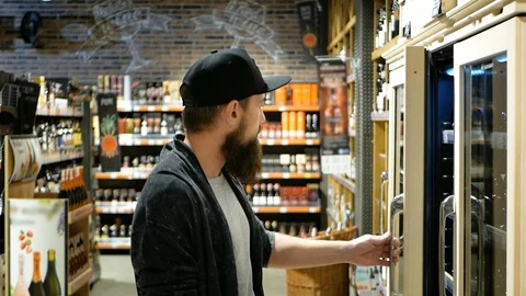 This should be fine. Side view of handsome young man holding bottle of wine and Video stock 98944233