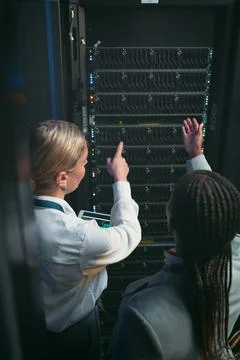 Should we try without that. two unrecognizable IT specialists standing in the 스톡 사진
