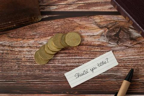 Should you tithe, handwritten text, golden coin money, and holy bible Stock Photos
