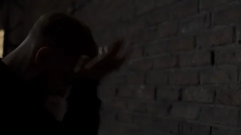 Shoulder camera shot in 4K of a angry handsome blond young man in hooded sweater Stock-Footage 107528449