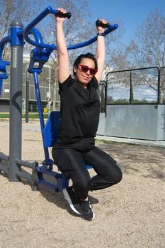 Shoulder exercises in the park Stock Photos