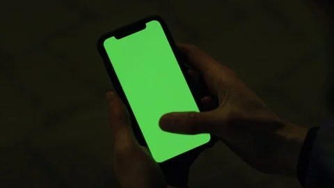 Shoulder level view on male hands vertically holding modern smartphone with high Stock Footage 106344276
