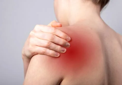 Shoulder pain and trigger points. Naked woman holding painful shoulder with red Stock Photos