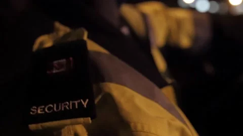 Shoulder of security guard in uniform driving security car with text of security Stock Footage 153888554