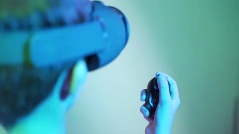 Shoulder shot of kid playing game using game pad with VR Stock Footage 148460220