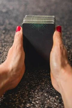 Shoulder view of a tarot reader gripping the tarot deck Stock Photos