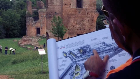 Shoulders guide explains with drawing help as it was an ancient Roman villa Stock Footage 90130590