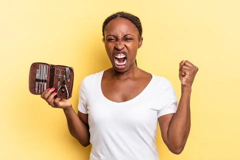 Shouting aggressively with an angry expression or with fists clenched celebra Stock Photos