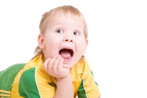 A shouting boy lays on the floor with the open mouth Stock Photos