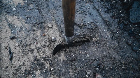 The shovel is stuck in the ground. Close-up with rotation Stock Footage 129713865