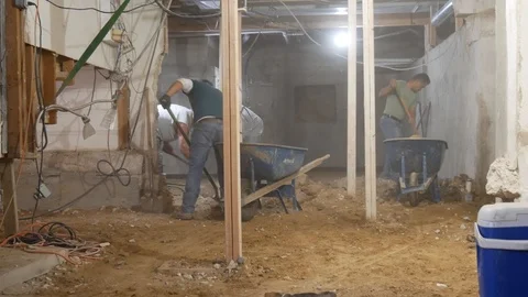 Shoveling Dirt Into Wheelbarrows Stock Footage 123044009