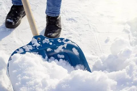 Shoveling snow in a backyard Stock Photos