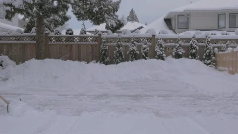 Shoveling snow in townhouse complex (variant). Not graded. Stock Footage 102979583