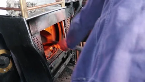 Shoving coal into a steam train 1 Video stock 153025542