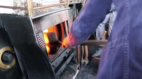 Shoving coal into a steam train 3 Video stock 153025531