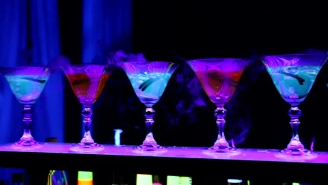 Show bartender. neon bartender, glowing drinks on the bar counter Stock Footage 232444405