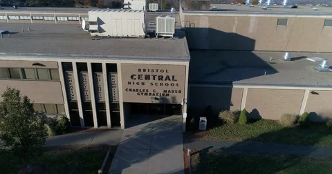 Show Bristol Central High School fly over building reveal football field Stock Footage 82326562